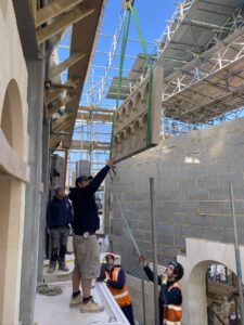 The AF Jones Stonemasonry site team installing a carved screen by crane at a complex build